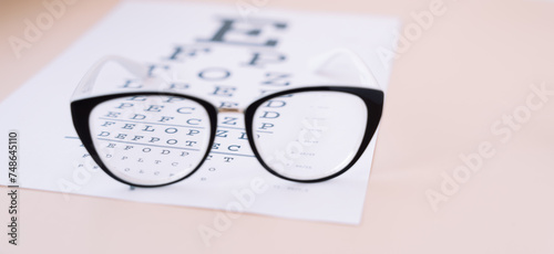Black frame vision glasses on Snellen chart.