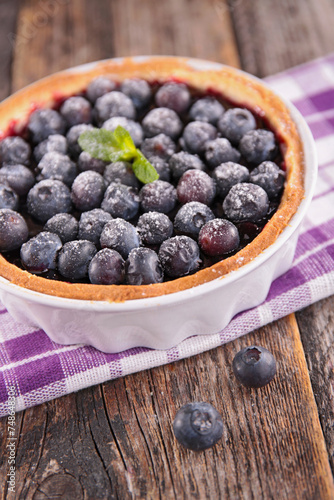 blueberry tart on wood background