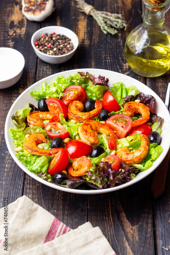 Salad with shrimps  tomatoes  olives and nuts. Healthy eating.