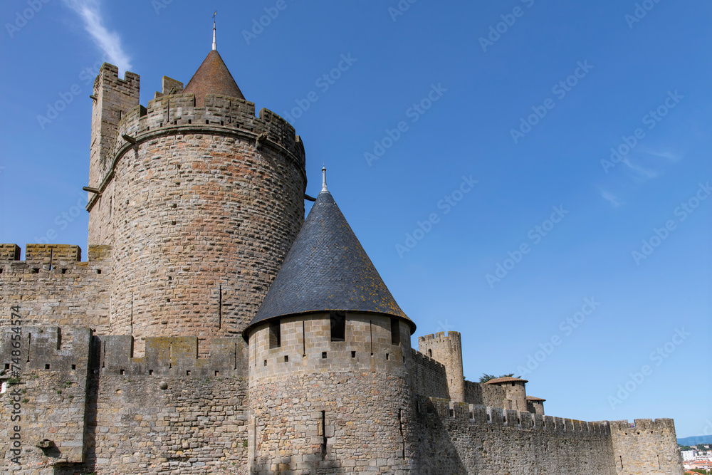 Low angle view of fortified wall with battlement and towers of the city of Carcassonne, a medieval fortress from Gallo-Roman period and part of UNESCO list of World Heritage Sites