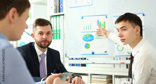 Bunch of businessmen sitting in office solving current problems portrait