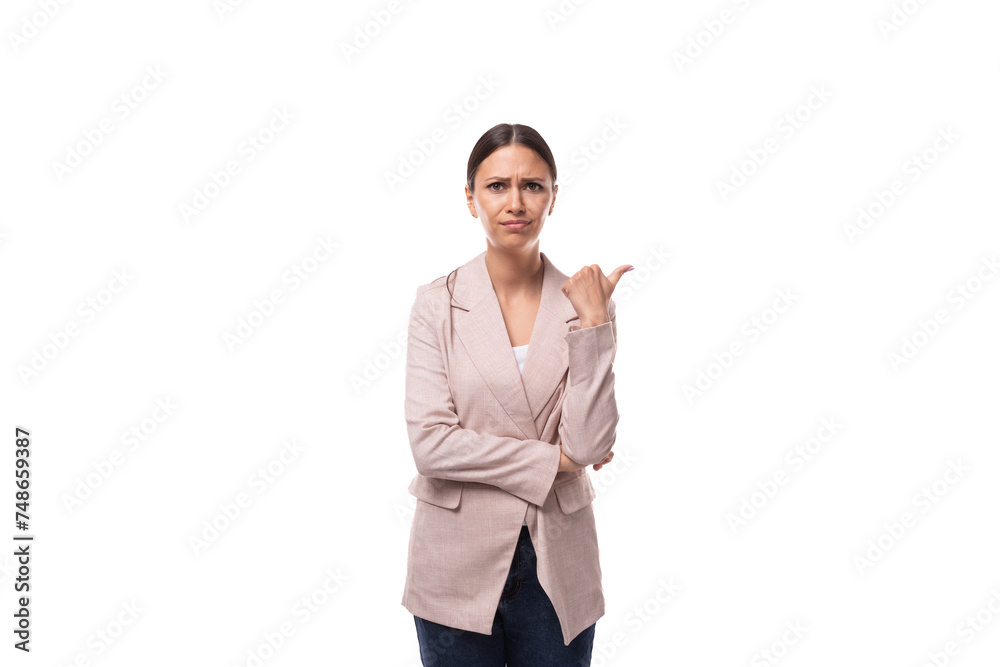 young surprised brunette with a smooth hairstyle dressed in a light jacket looks thoughtfully on a white background with copy space young surprised brunette with a smooth hairstyle dressed in a light jacket looks thoughtfully on a white background with copy space