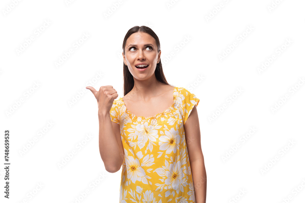 Caucasian young woman with straight black hair points her finger to the side Caucasian young woman with straight black hair points her finger to the side