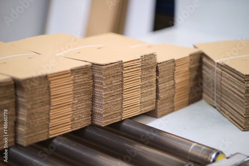 A pile of freshly made unprepared brown card board boxes fresh from manufacture. Cardboard box storage and transport solution in a cardboard box factory warehouse distribution