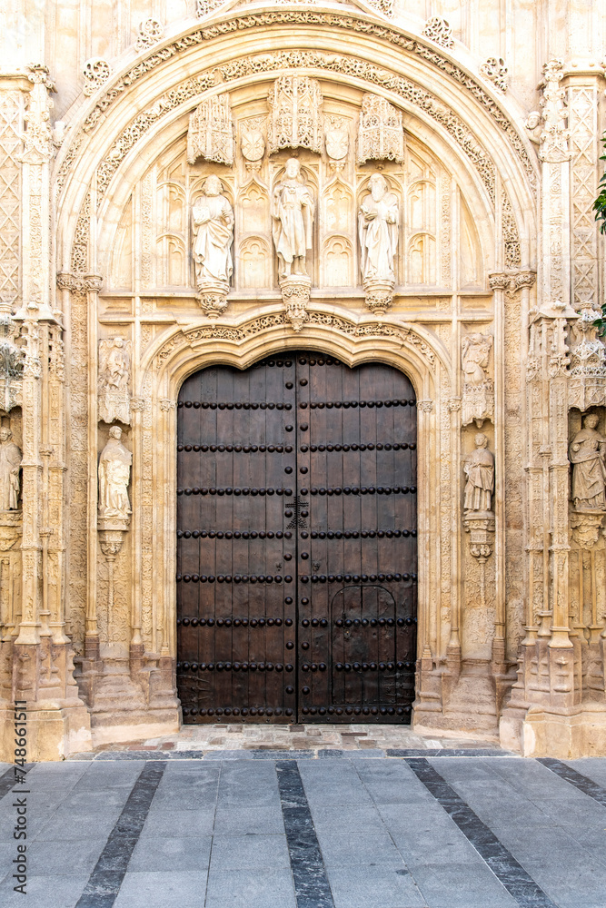 One of the large wooden entrance doors with ornaments of the of Mosque–Cathedral of Cordoba or Cathedral of Our Lady of the Assumption or Mezquita in Cordoba, Spain