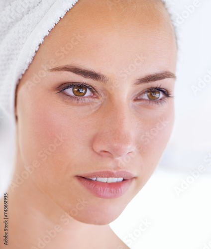Skincare, natural beauty and face of woman in bathroom at home for wellness, clean or thinking in the morning. Spa, towel or cosmetics of person in facial treatment for health, dermatology or closeup