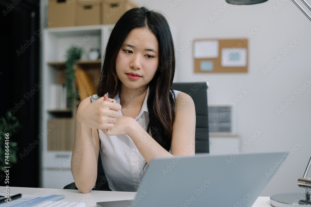 Businesswoman is doing a stretchy posture due to sitting in the office for too long, office syndrome concept. Businesswoman is doing a stretchy posture due to sitting in the office for too long, office syndrome concept.