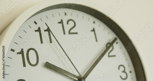 close-up of a white wall clock showing the time 10:10 photo