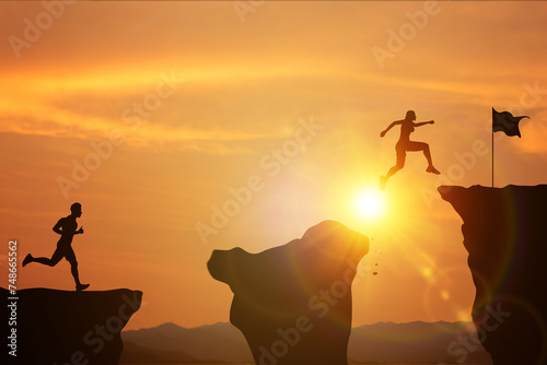 Effort and commitment to success. Silhouette of women and men competing jumping over a cliff to reach finish line on mountain with bright sunny. concept of setting goals for victories and training