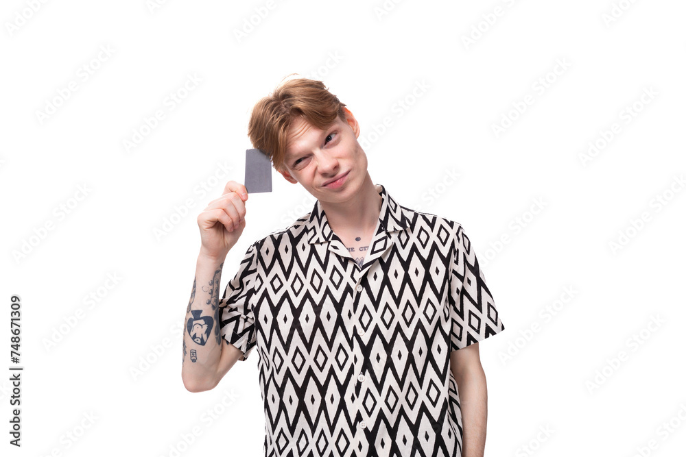young caucasian man with reddish golden hair holding a credit card with mockup young caucasian man with reddish golden hair holding a credit card with mockup
