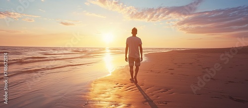 a man is walking on the beach in the afternoon