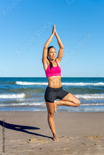 Middle aged woman exercising on the beach this summer