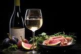 Delicious prosciutto, cheese, and figs snacks for wine pairing on chic black backgr l ound