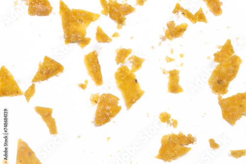Close-up separated crashed of crispy corn tortilla nachos chips with crumble isolated on white background clipping path