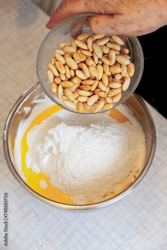 Ageless Artistry: Senior's Hands Blend Flour, Butter, Egg, and Almonds