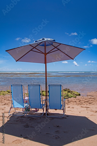 beach chairs and umbrella on the beach in summer day