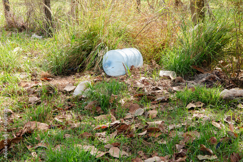 large plastic bottle polluting the environment. waste in the environment.