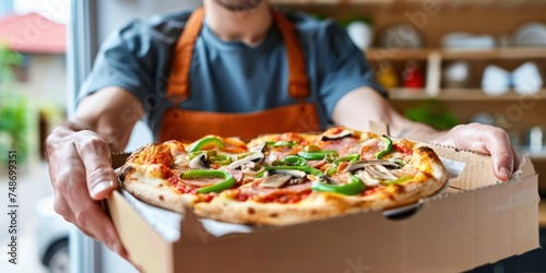 Closeup fresh hot pizza with delivery man blur background 