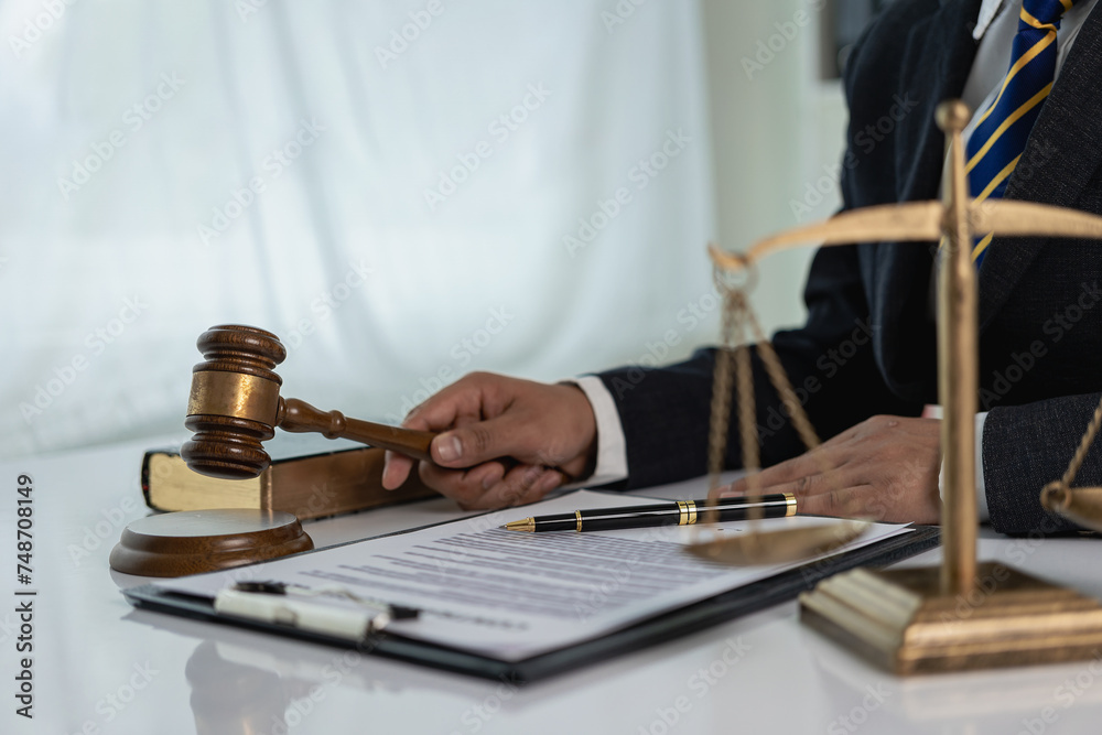Businessman lawyer close-up working or reading law book at work for lawyer concept, consulting judge, hammer with lawyer justice or lawyer, legal advice and services.