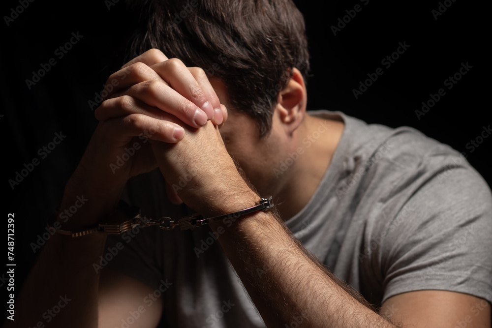 Man, criminal and handcuffs for interrogation, crime or money laundering in arrest on table in room. Man, criminal and handcuffs for interrogation, crime or money laundering in arrest on table in room.