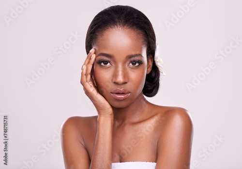 Portrait, beauty and serious with natural black woman in studio on white background for wellness. Face, skincare and cosmetics with confident young aesthetic model at spa for dermatology treatment photo