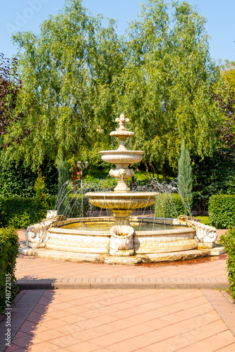 A classic round fountain in a summer park