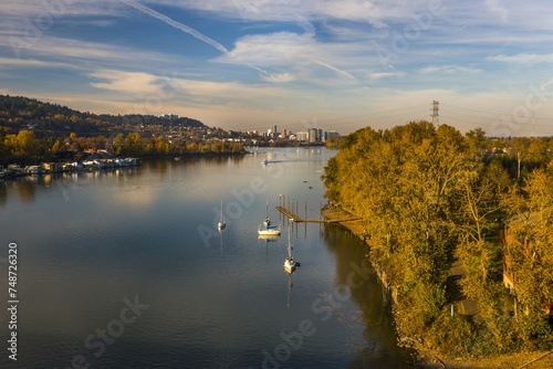 Recreation activity on the Willamette River in Milwaukie, Oregon. Portland cityscape on the background