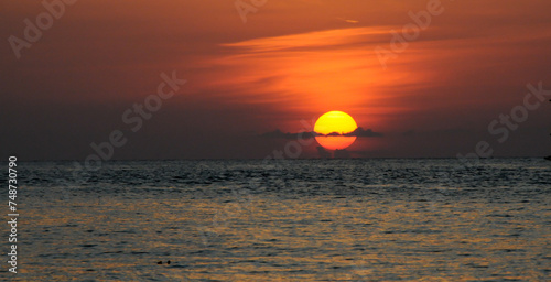 A red tropical sunset over the sea photo