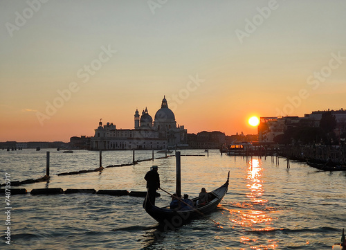Gondola at sunset in Venice, with Basilica della Salute in the background