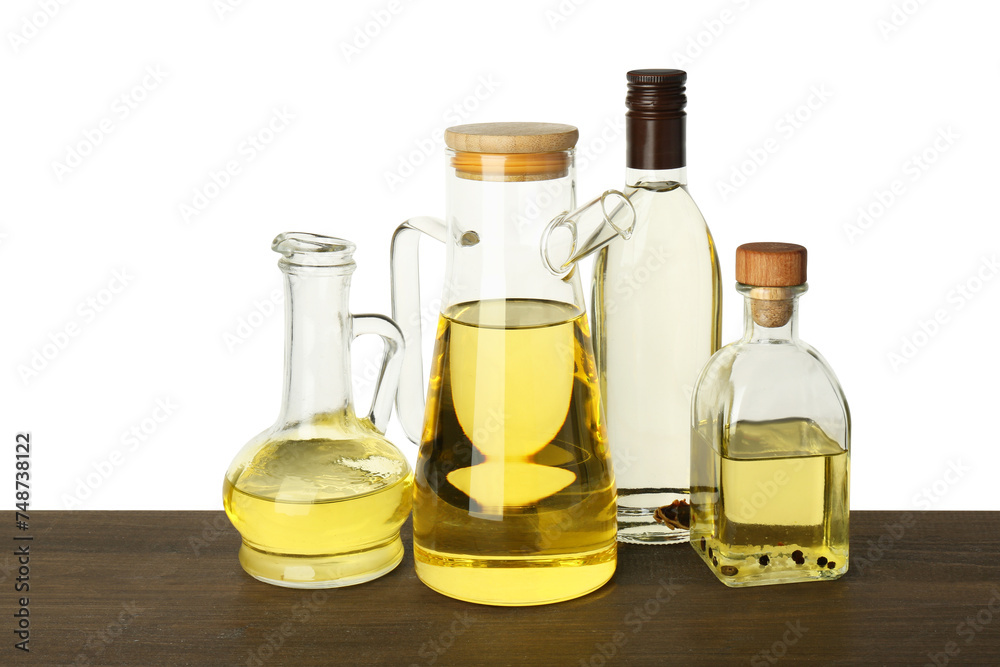 Vegetable fats. Different cooking oils on wooden table against white background Vegetable fats. Different cooking oils on wooden table against white background