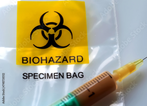 Biohazard specimen bag with a syringe and brown liquid
