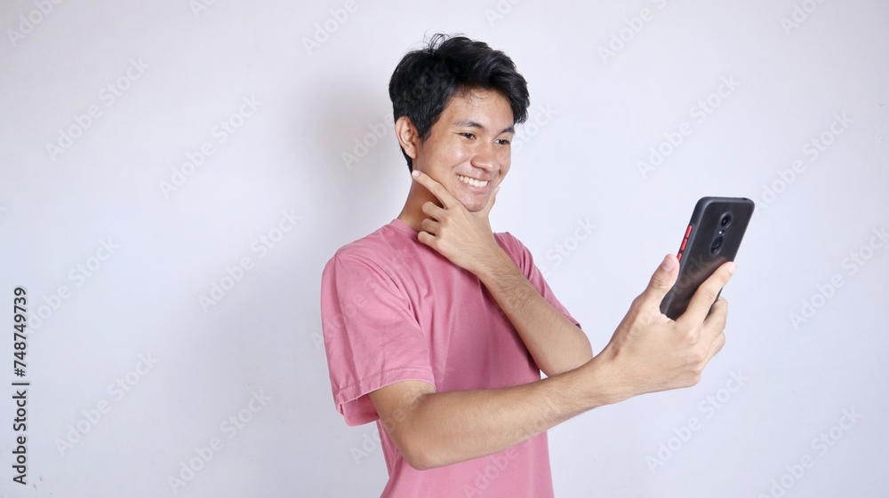 excited and smiling Asian man with smartphone holding gesture excited and smiling Asian man with smartphone holding gesture