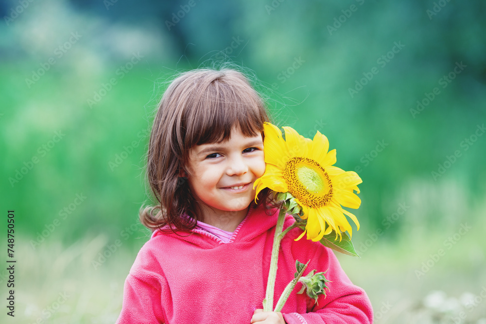 Little girl with sunflower outdoors Little girl with sunflower outdoors