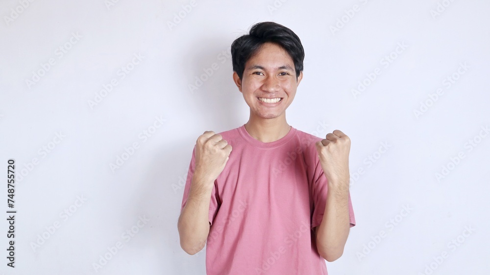 asian man with very excited and winning gesture asian man with very excited and winning gesture