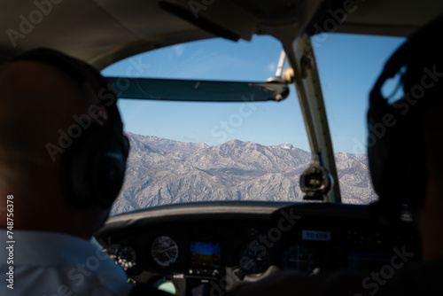 Two Pilots Flying Over Mountainous Terrain