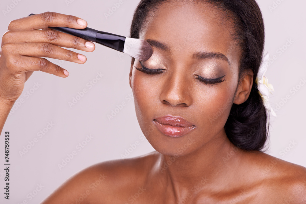 Makeup,, beauty and face of black woman with brush in studio with cosmetics, wellness and eyeshadow. Salon aesthetic, dermatology or isolated person for cosmetology, spa or facial on white background