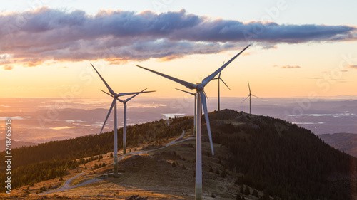 A group of wind mills on a mountain ridge in Austria during sunrise in Austria