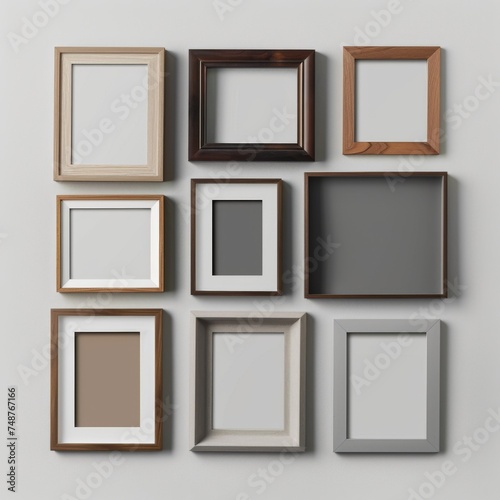 A variety of empty picture frames arranged in a flat lay configuration on a plain backdrop.