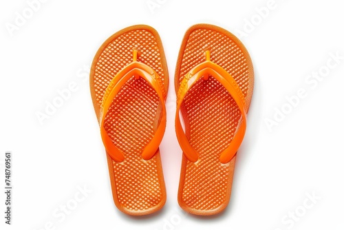 On white background, orange flip flops stand out. Top view.