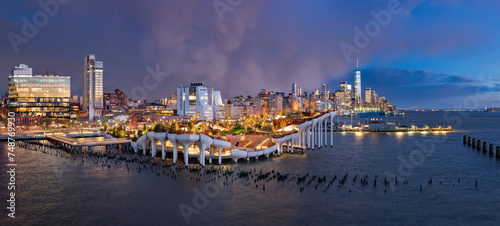 New York City, Little Island public park at twilight with view of the World Trade Center after a storm. Elevated park with amphitheater at Hudson River Park (Pier 55), West Village, Manhattan