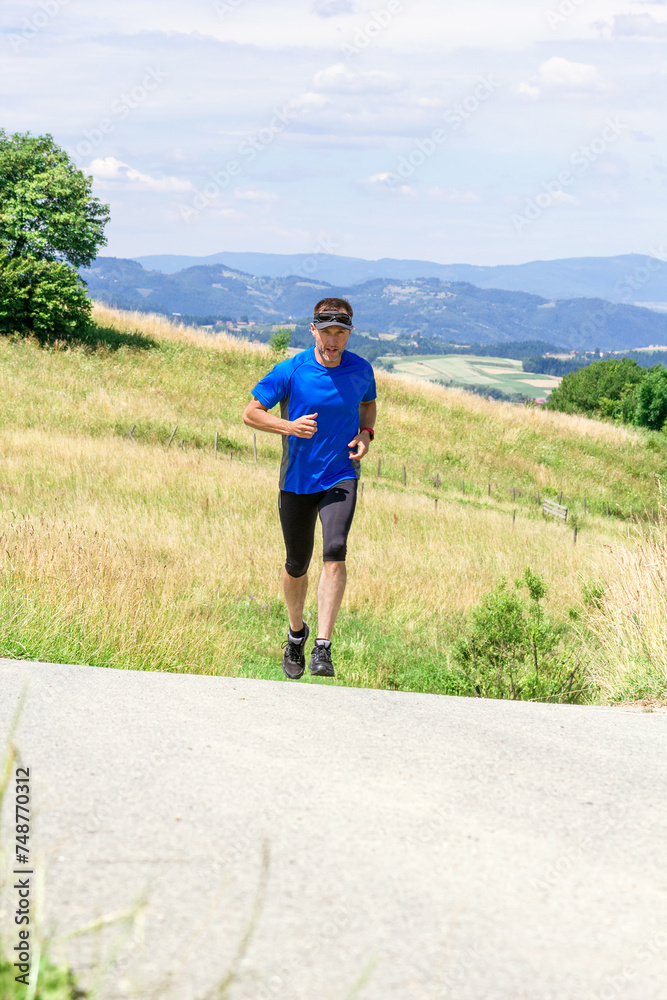 Runner athlete running on road at mountains background