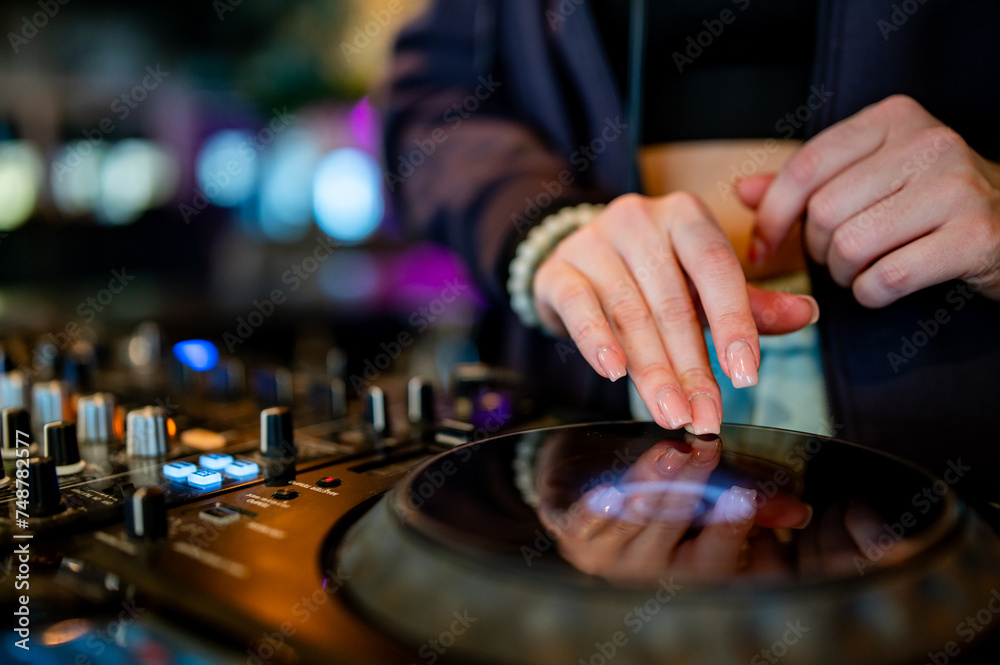 close-up of hands skillfully adjusting knobs and sliders on a professional DJ mixer, illuminated by colorful lights. The mood conveys focus and control during a live music event close-up of hands skillfully adjusting knobs and sliders on a professional DJ mixer, illuminated by colorful lights. The mood conveys focus and control during a live music event