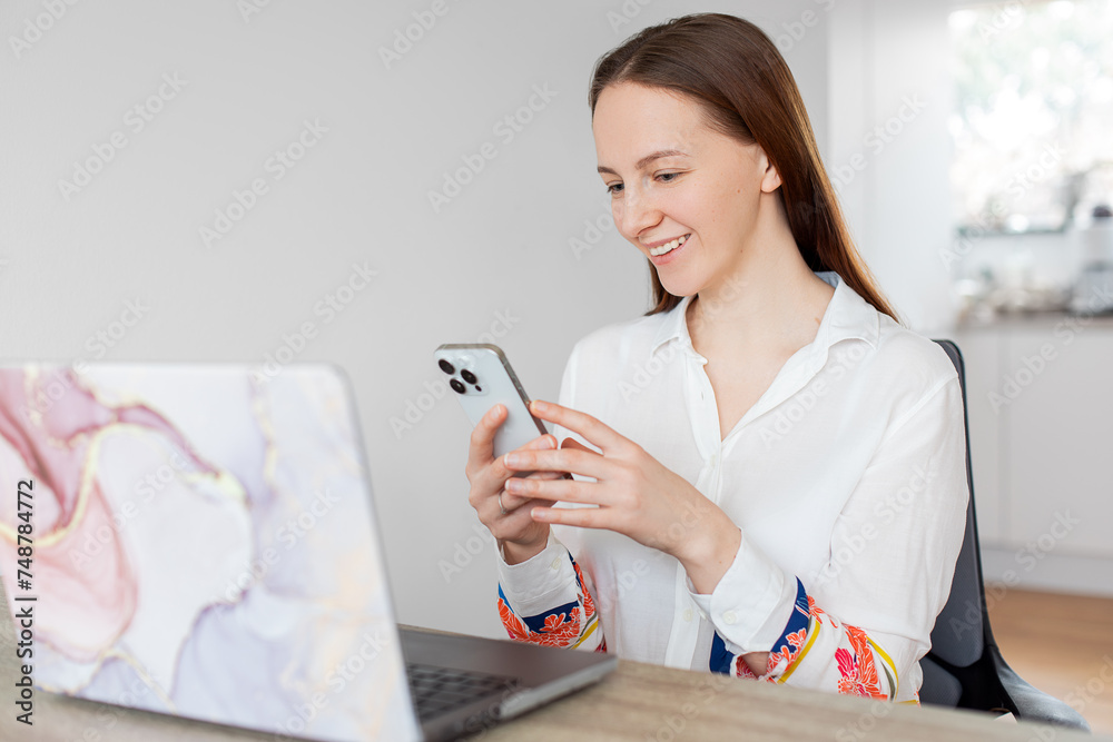 woman using computer. woman with laptop. Young european businesswoman beautiful charming smiling and talking on the mobile phone in the office woman using computer. woman with laptop. Young european businesswoman beautiful charming smiling and talking on the mobile phone in the office