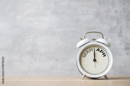 Hello April Changed from March month with vintage alarm clock on table background. Calendar, Monthly, New Start, Resolution, Goals, Plan, Action and Mission Concept