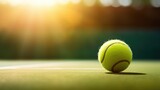 Macro photo of Tennis ball on grass with blurred stadium background. Sports backdrop with copy space and sun ray