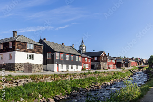 Roros presents a harmonious riverside setting where historic wooden architecture and the prominent church clock tower capture the essence of this Norwegian heritage town