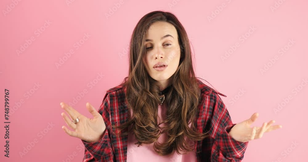 Attractive brunette woman put palms on head spreading hands say what isolated on pink background. Displeased dissatisfied worried nervous young woman. What? Spread raised hands, rolling eyes. Attractive brunette woman put palms on head spreading hands say what isolated on pink background. Displeased dissatisfied worried nervous young woman. What? Spread raised hands, rolling eyes.