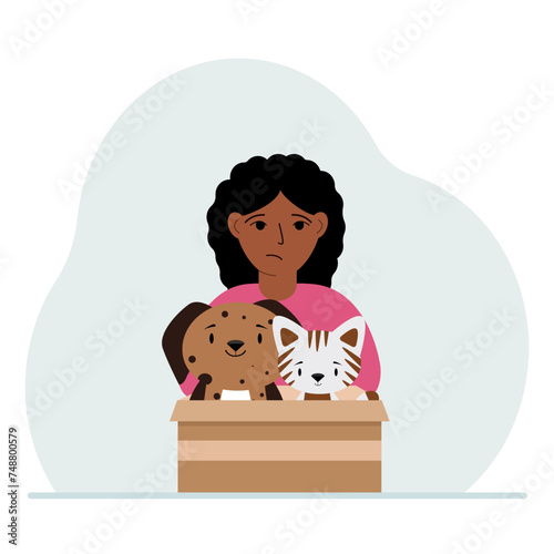 A little girl holds a cardboard box with a cat and a dog. The concept of rescue, help and care for pets.