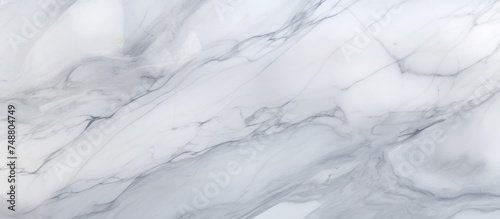 A detailed close-up view of a white marble texture, showcasing intricate veins and patterns on the surface. The smooth texture of the marble is highlighted in this shot,
