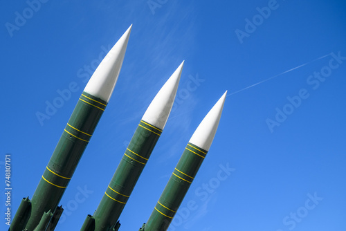 Anti-aircraft missiles aimed at the blue sky. Concept of defense, war, peace. photo